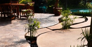 Natural Stone Pond Border Against Colored Textured Concrete